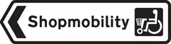 Direction to a shopping area which provides a shopmobility service for disabled people — UK road sign