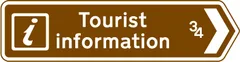 Direction and distance to a Tourist Information point or centre — UK road sign