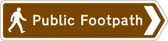 Direction to or along a public footpath — UK road sign