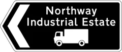 Direction to destination shown of route advised for goods vehicles — UK road sign