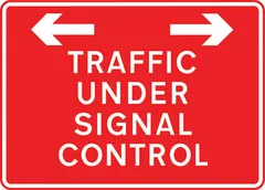 Traffic on road ahead is being controlled by portable light signals — UK road sign