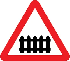 Level crossing with gate or barrier ahead — UK road sign