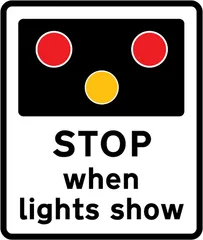 Warning of light signals at a level crossing without a gate or barrier ahead — UK road sign