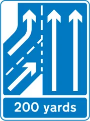 Additional traffic lane joining from the left ahead in 200 yards. Traffic on the main carriageway has priority over joining traffic — UK road sign
