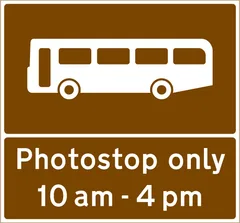 Stopping place for buses used for carrying tourists to allow passengers to take photographs — UK road sign